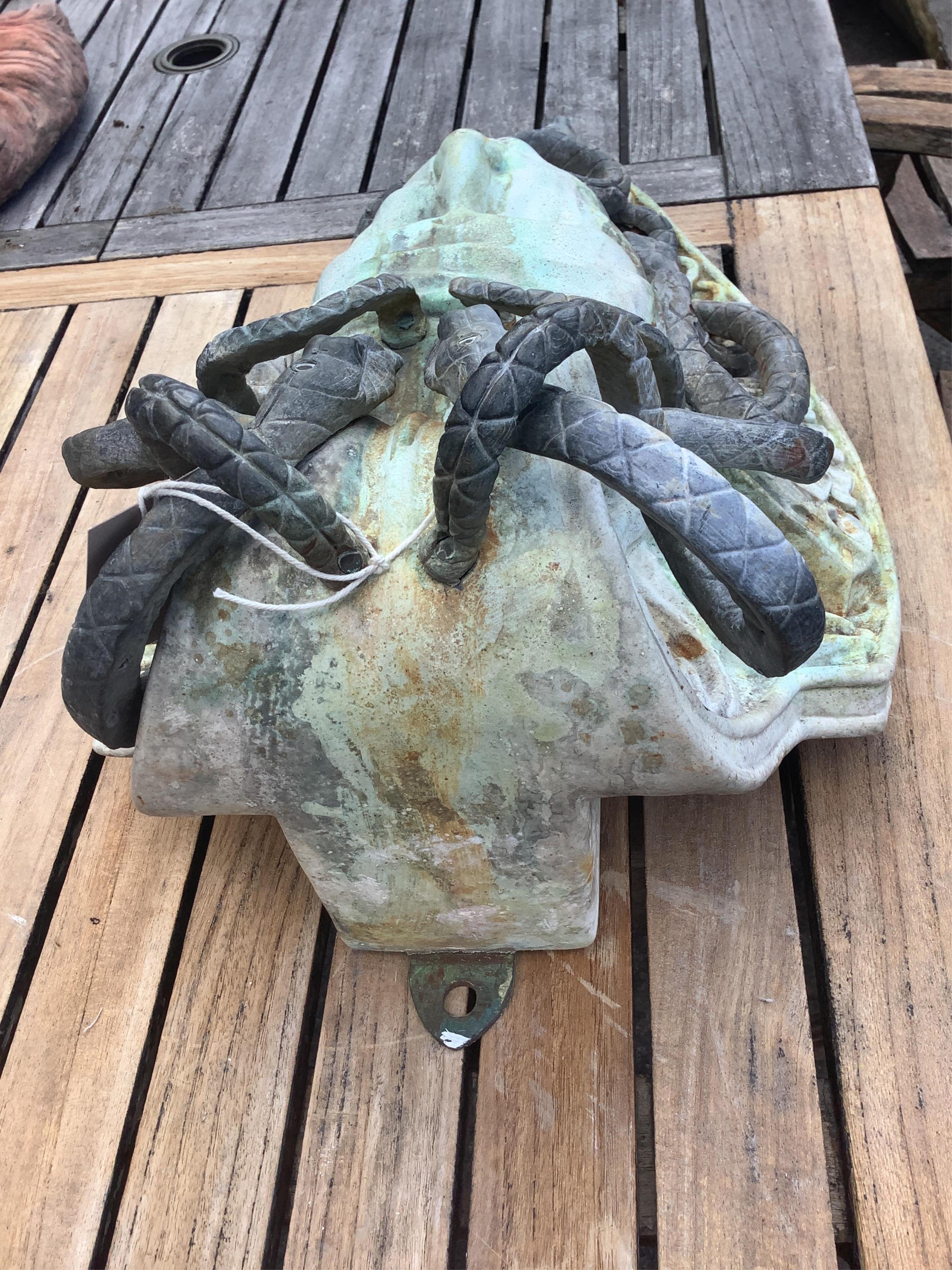 A reconstituted marble and lead Medusa wall fountain head, height 54cm